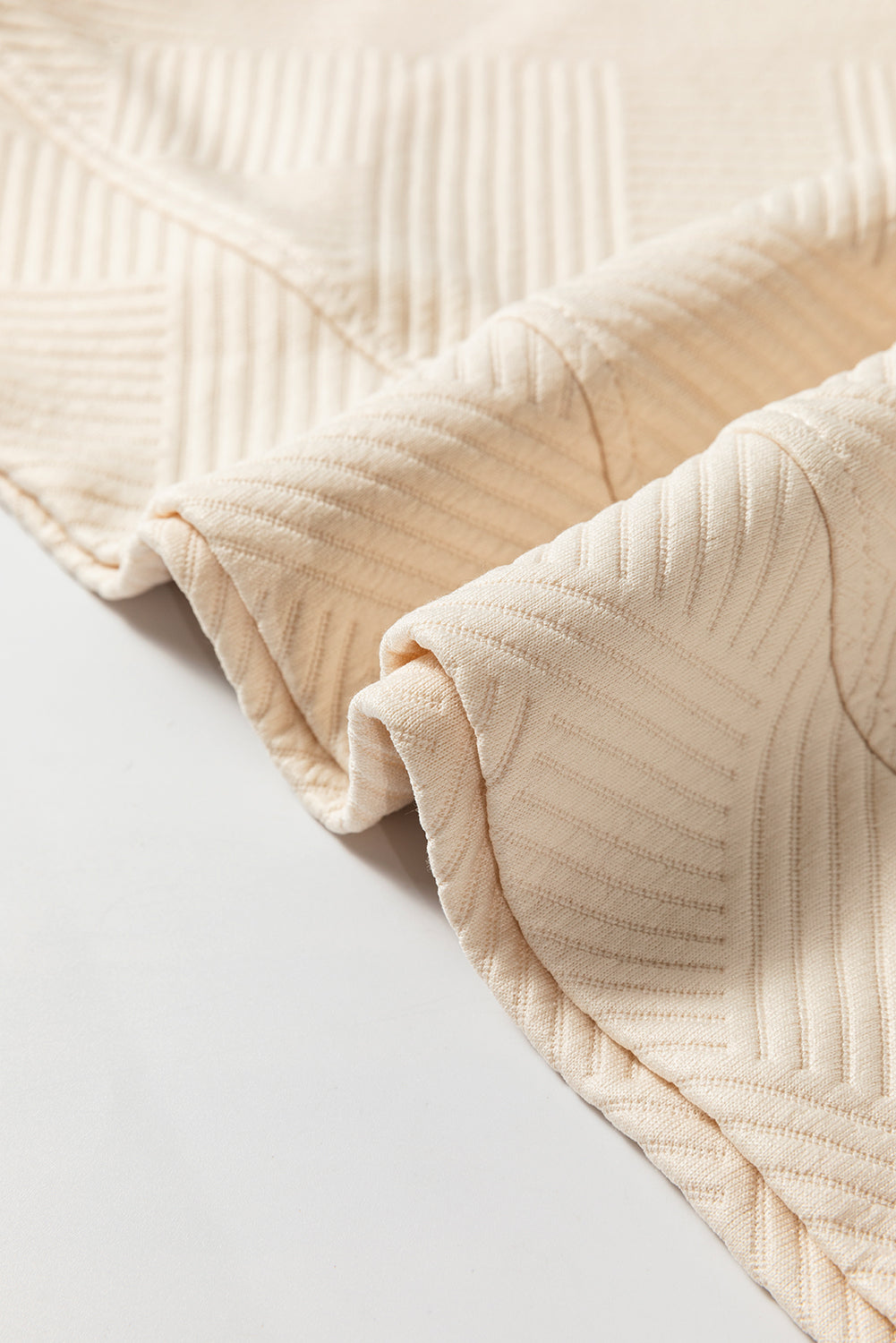 Close-up of a beige textured fabric on a light gray background