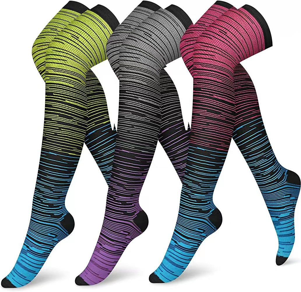 Three pairs of striped knee-high socks in green, gray, and pink with blue accents on a white background.