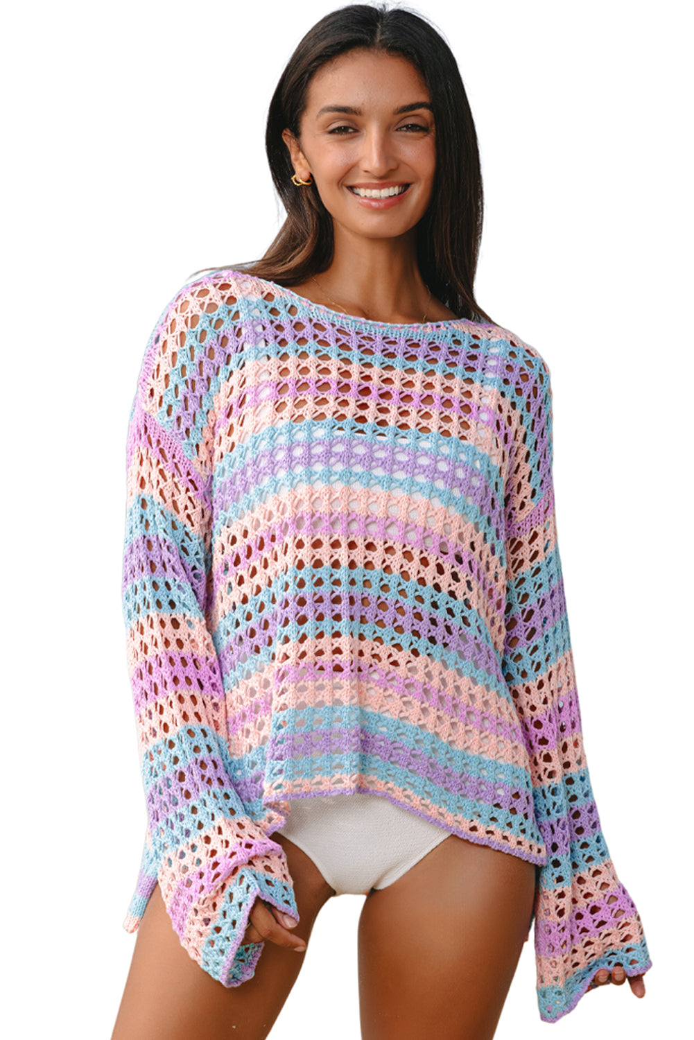 Woman wearing a colorful crochet sweater on a white background