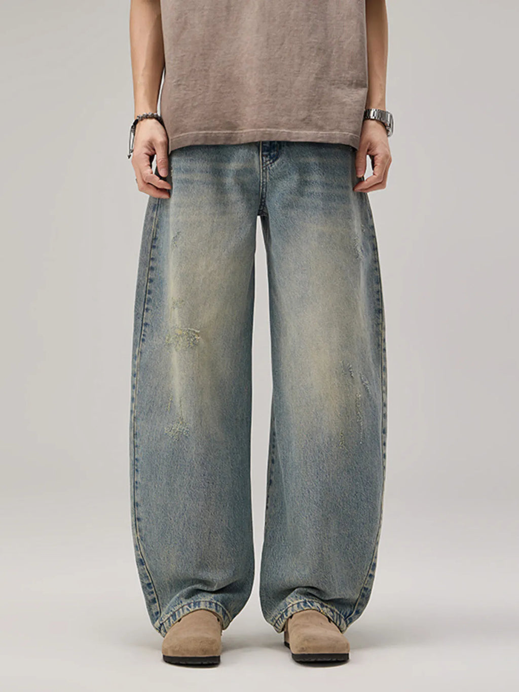 Model wearing a pair of Men's Vintage Oversized Wash Wide Leg Jeans