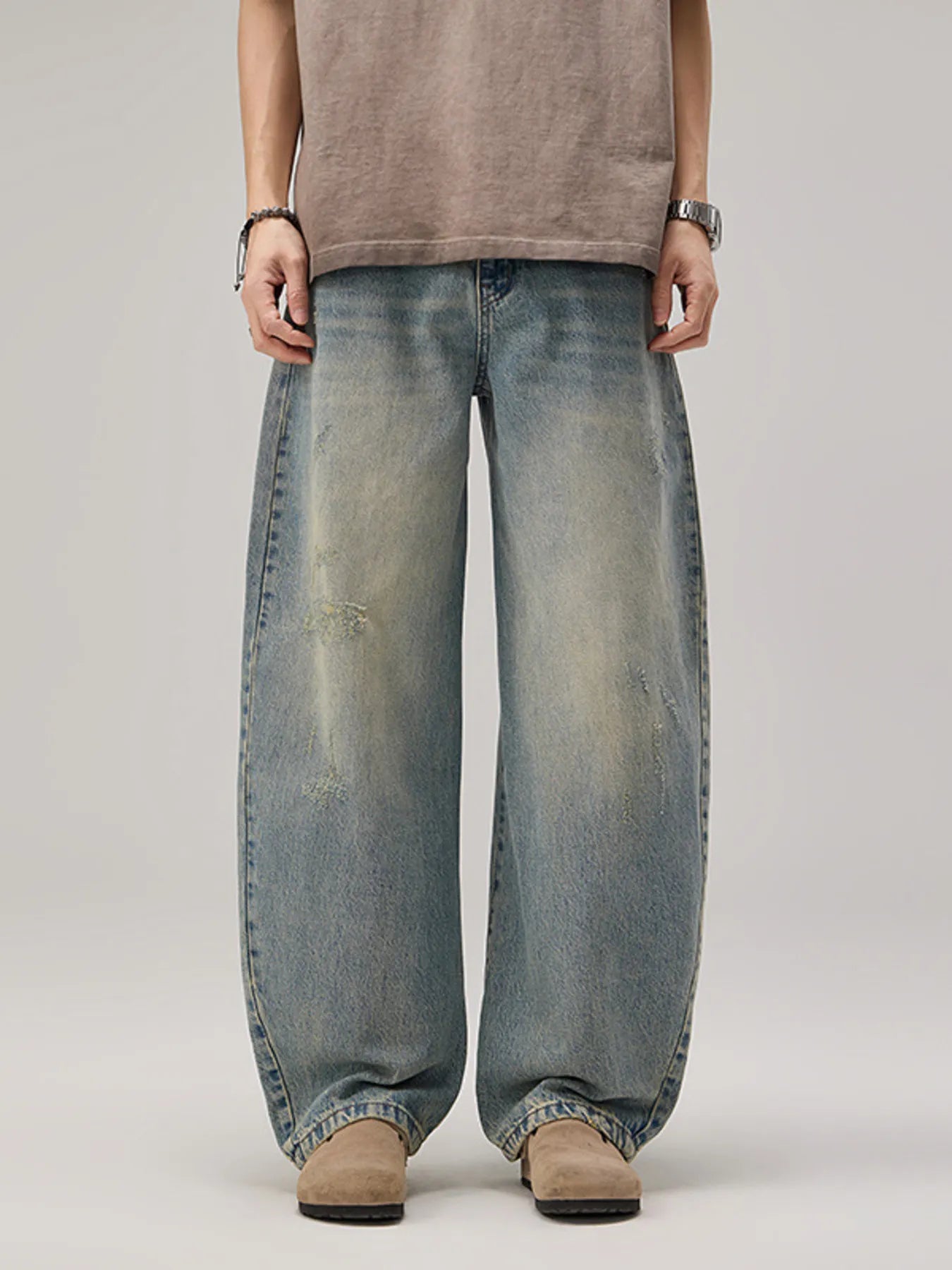 Model wearing a pair of Men's Vintage Oversized Wash Wide Leg Jeans