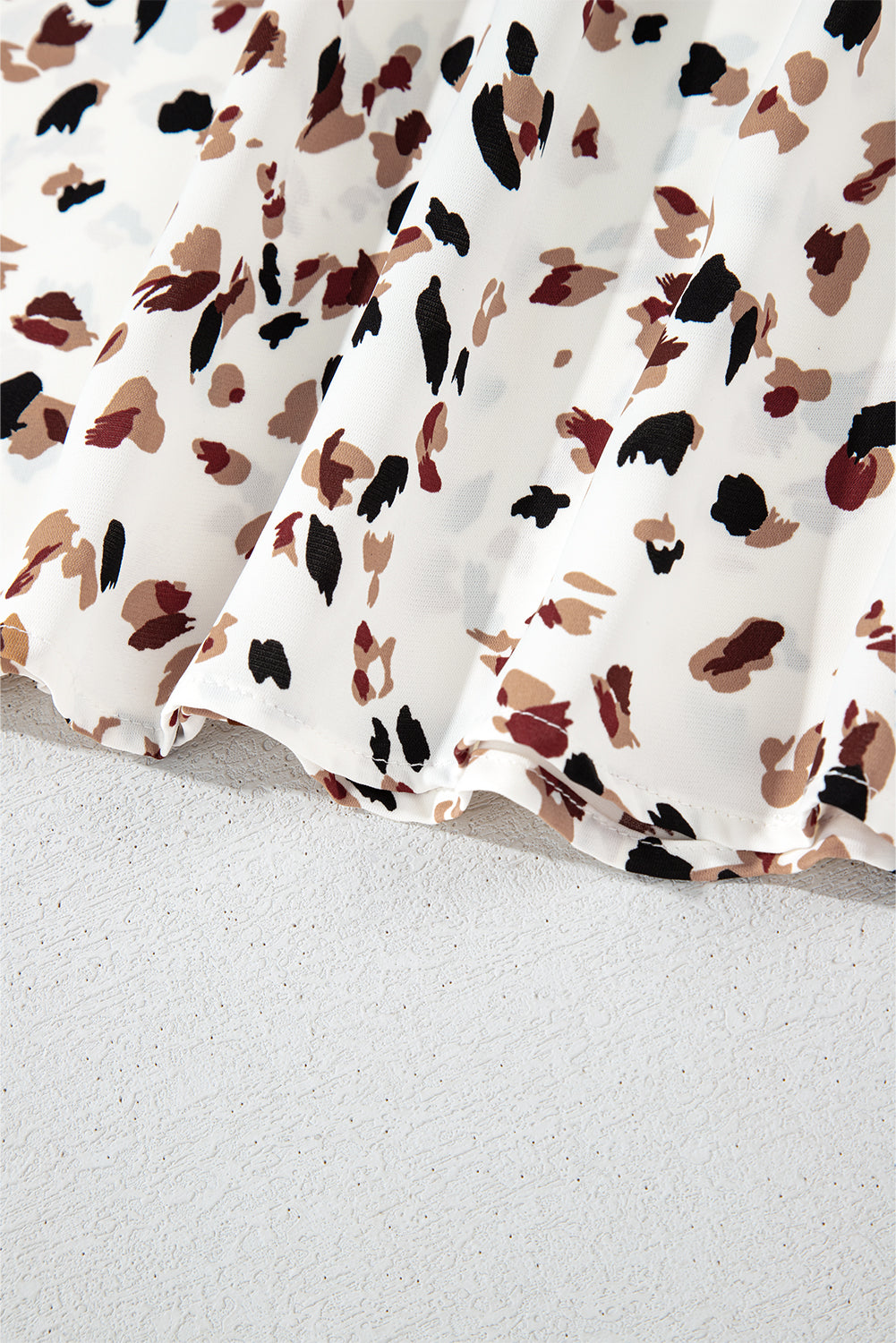 Close-up of a fabric with a floral pattern on a light gray background