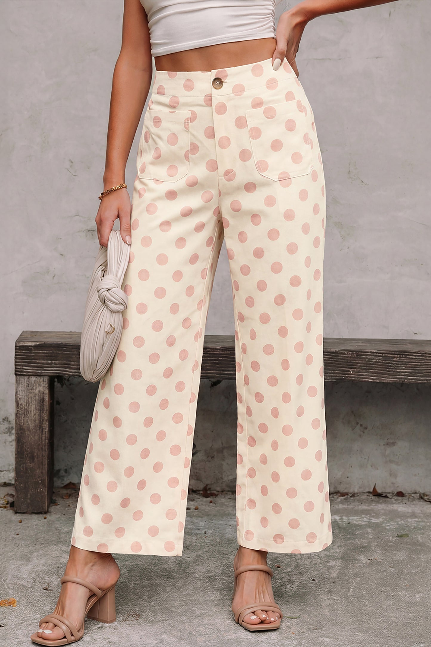 Person wearing polka dot white-pink pants with a neutral background
