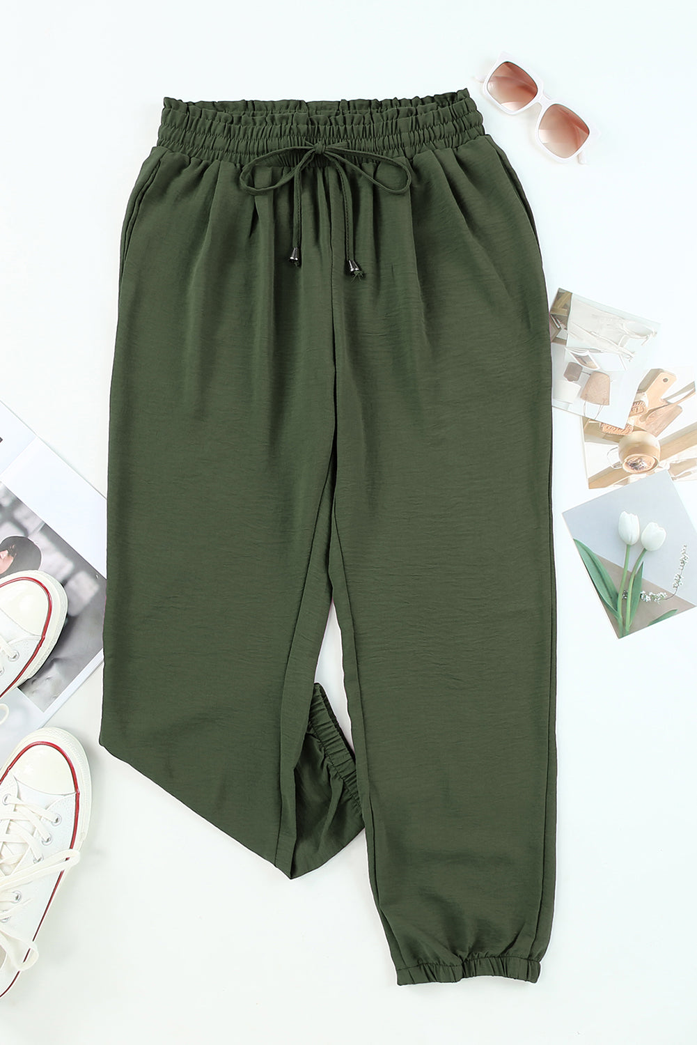 Green pants with drawstring waist on a white background front view