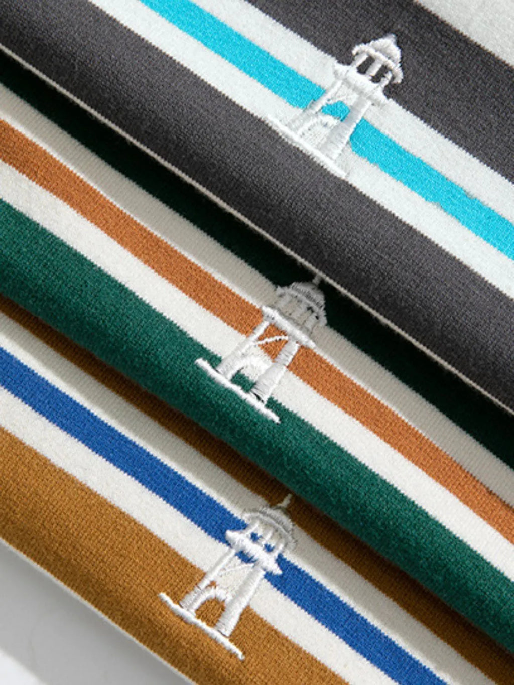Close-up of three striped stripe shirts of different colors with logo