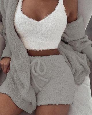 Person wearing a white textured top and gray shorts with a matching robe.