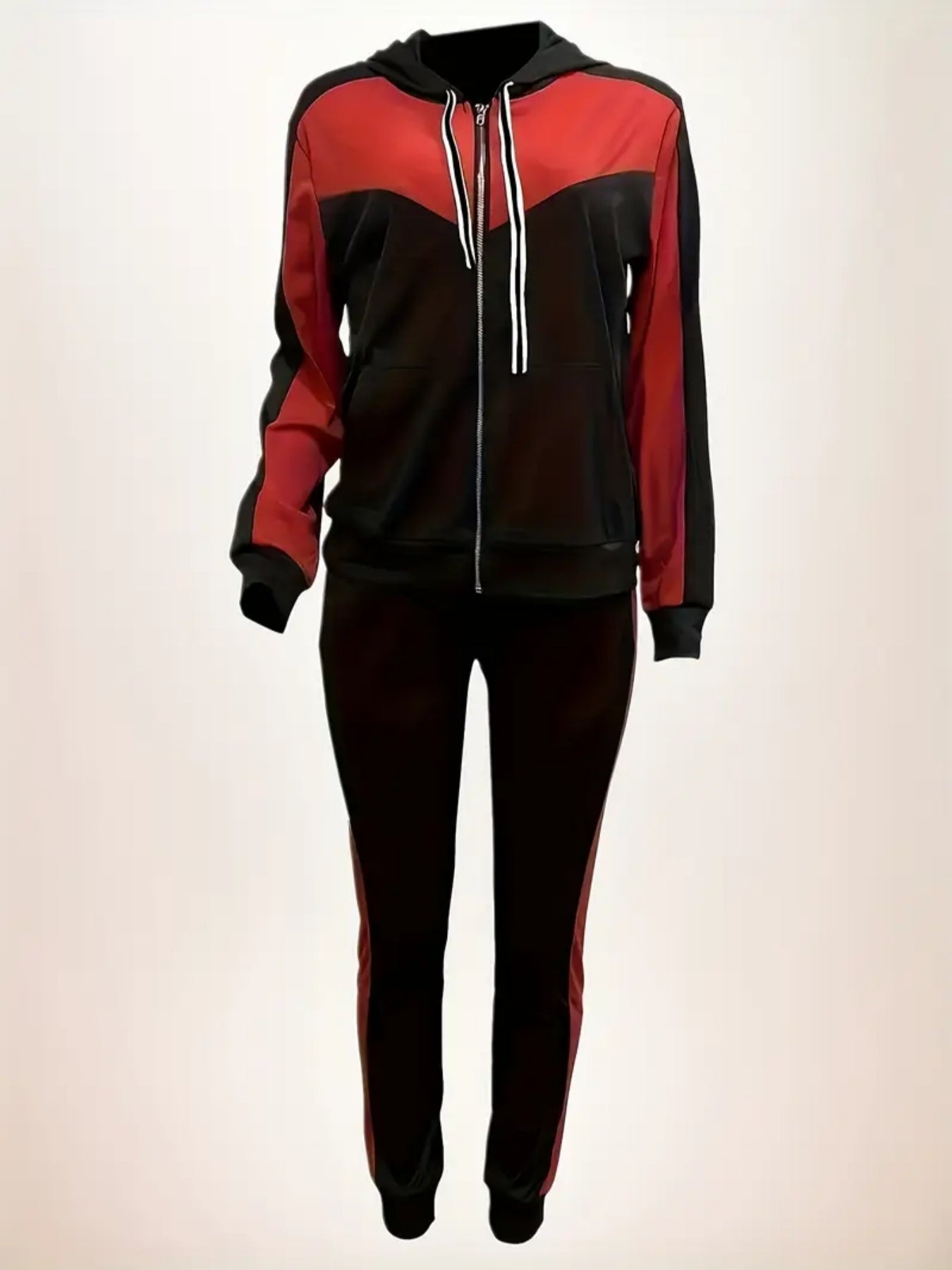 Red and black tracksuit on a light beige background