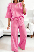 Person wearing a pink outfit in a living room setting
