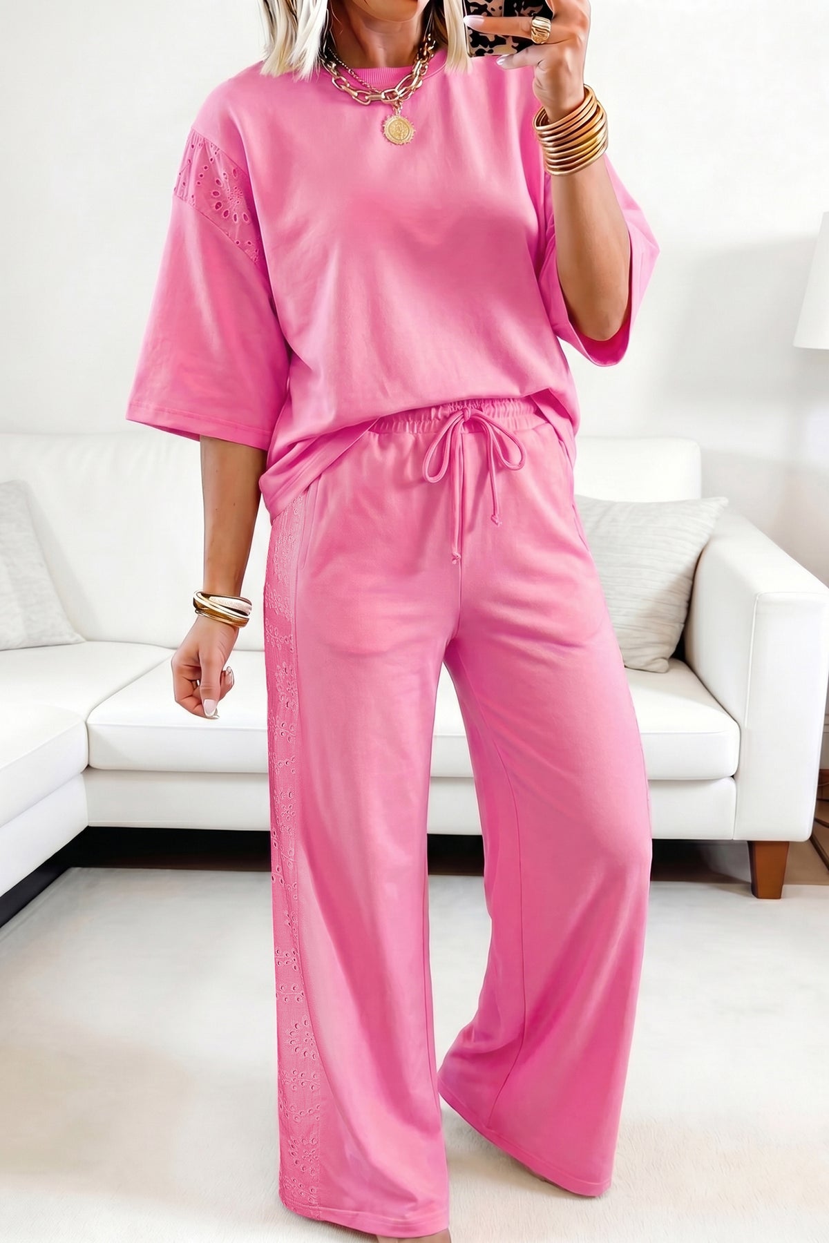 Person wearing a pink outfit in a living room setting
