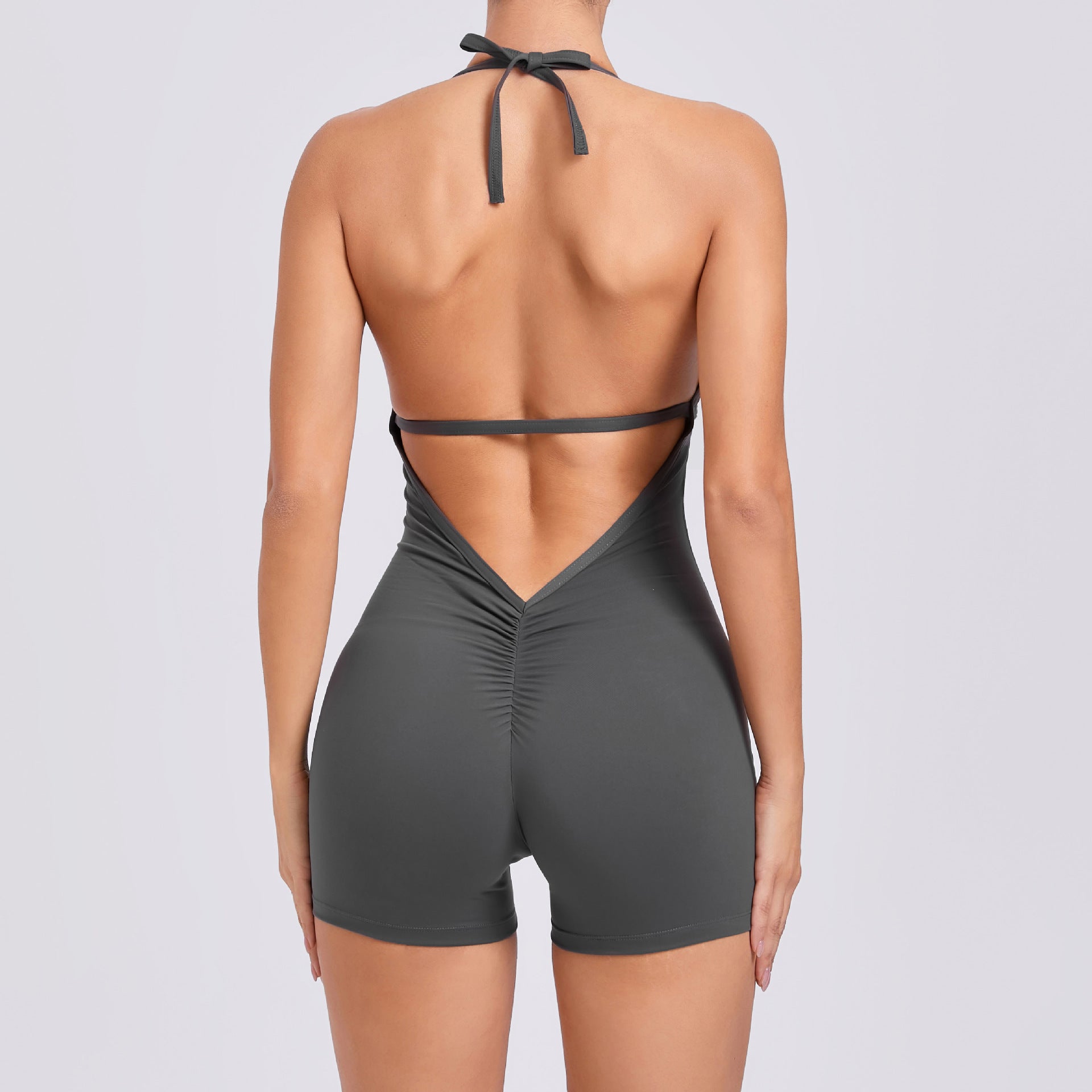 Gray swimsuit with open back design on a plain background