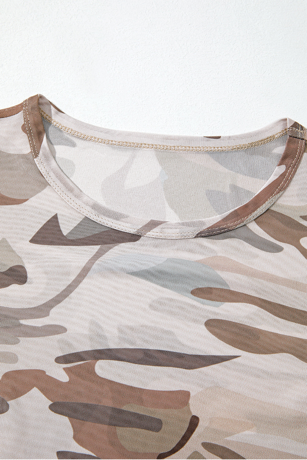 Camouflage-patterned shirt with mesh neckline on a white background