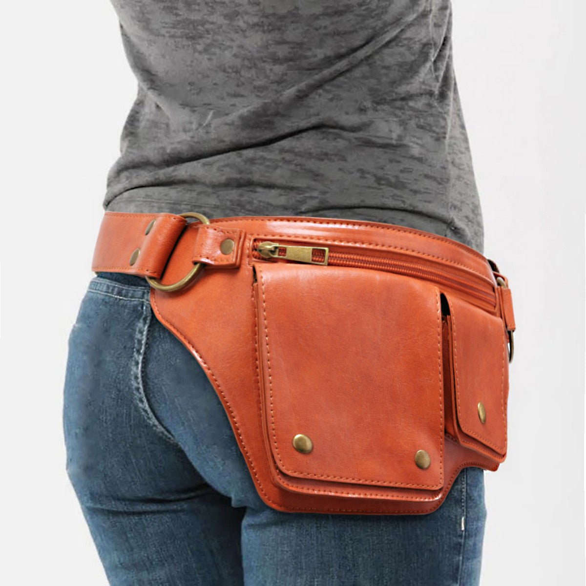 Person wearing a brown leather waist bag on a white background