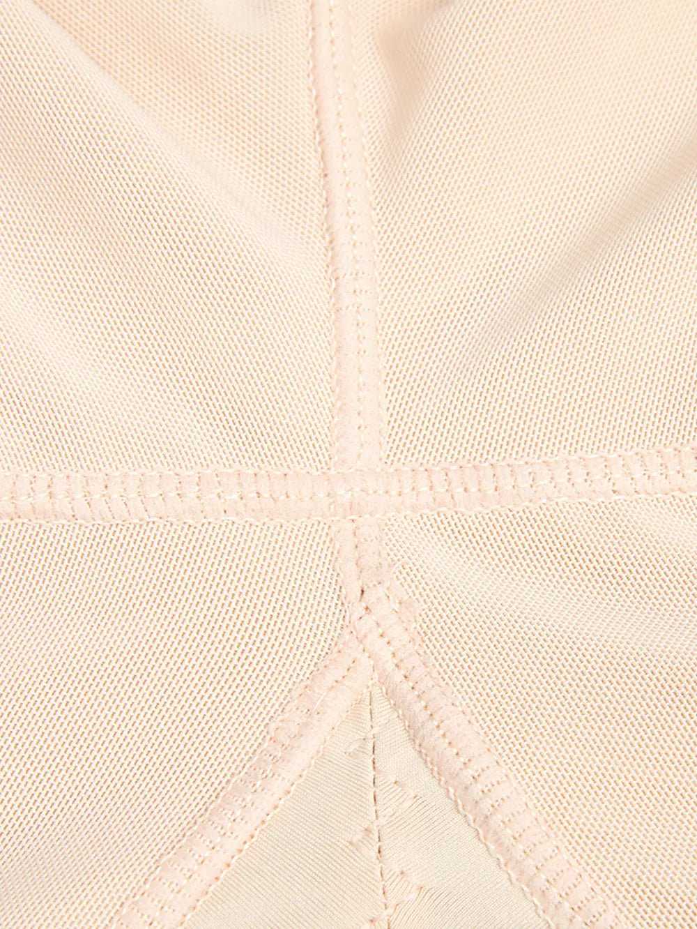 Close-up of beige fabric with a diamond pattern and stitching detail