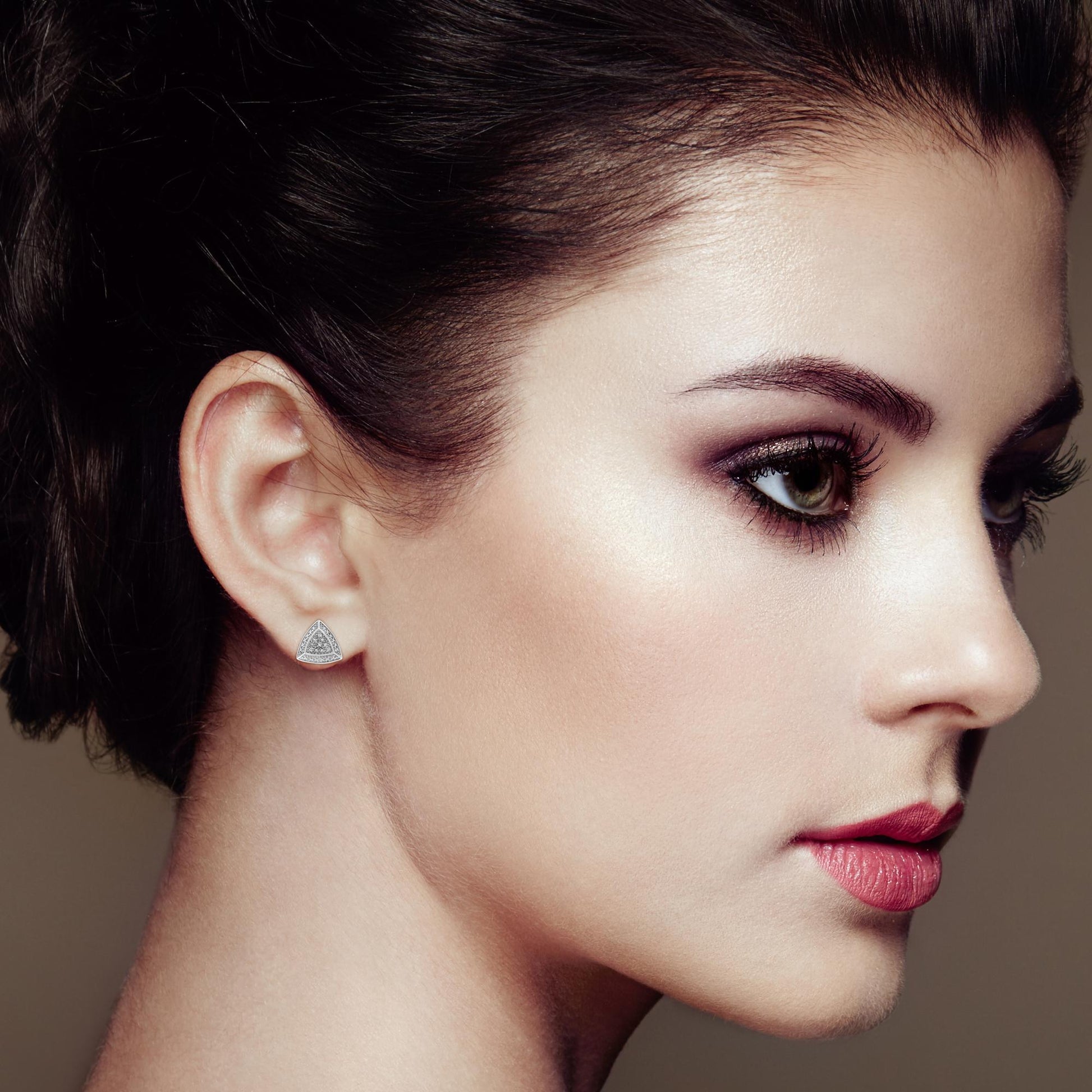 Close-up of a woman's profile with a neutral background