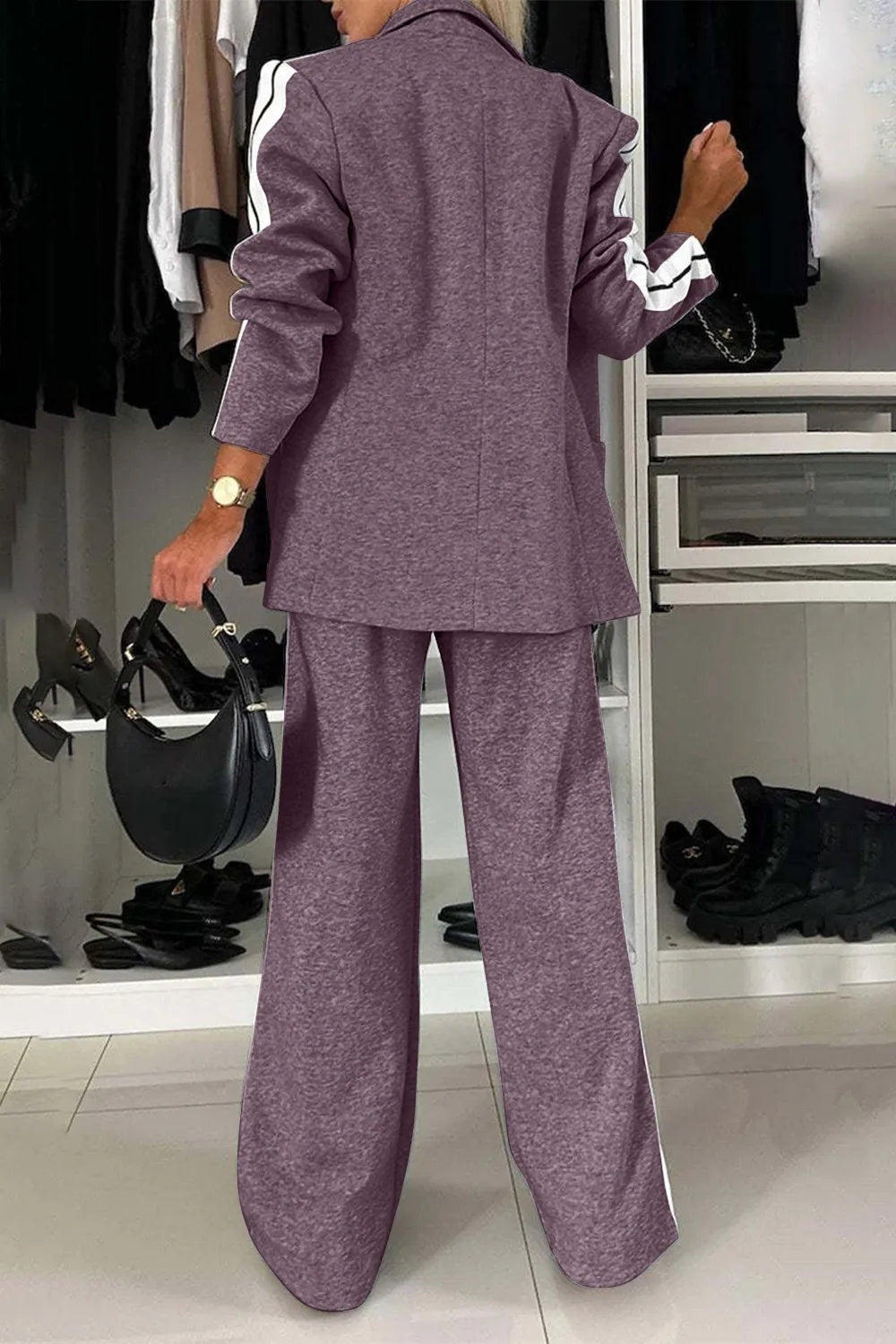 Person wearing a purple suit in a clothing store.