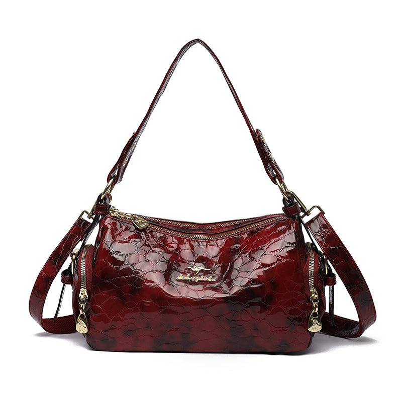 Red textured handbag with gold accents on a white background