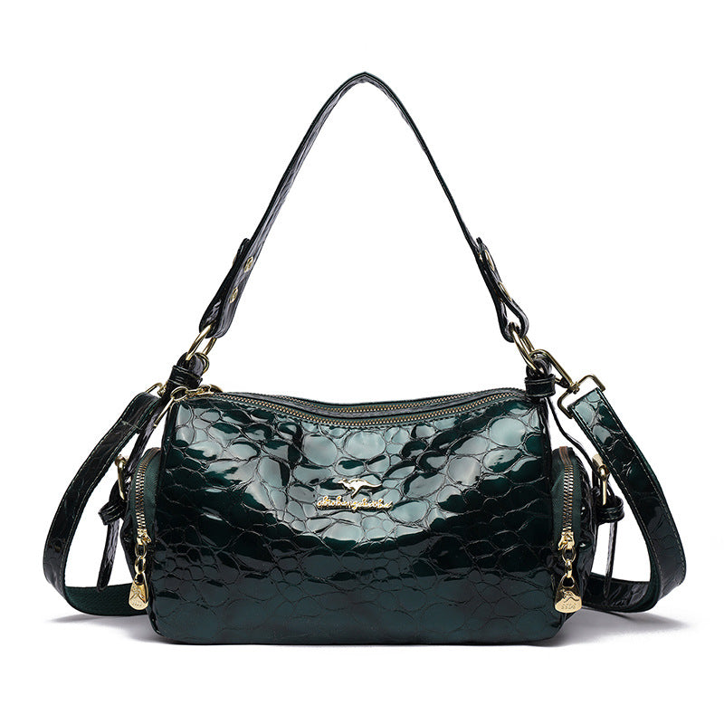 Green textured handbag with gold accents on a white background