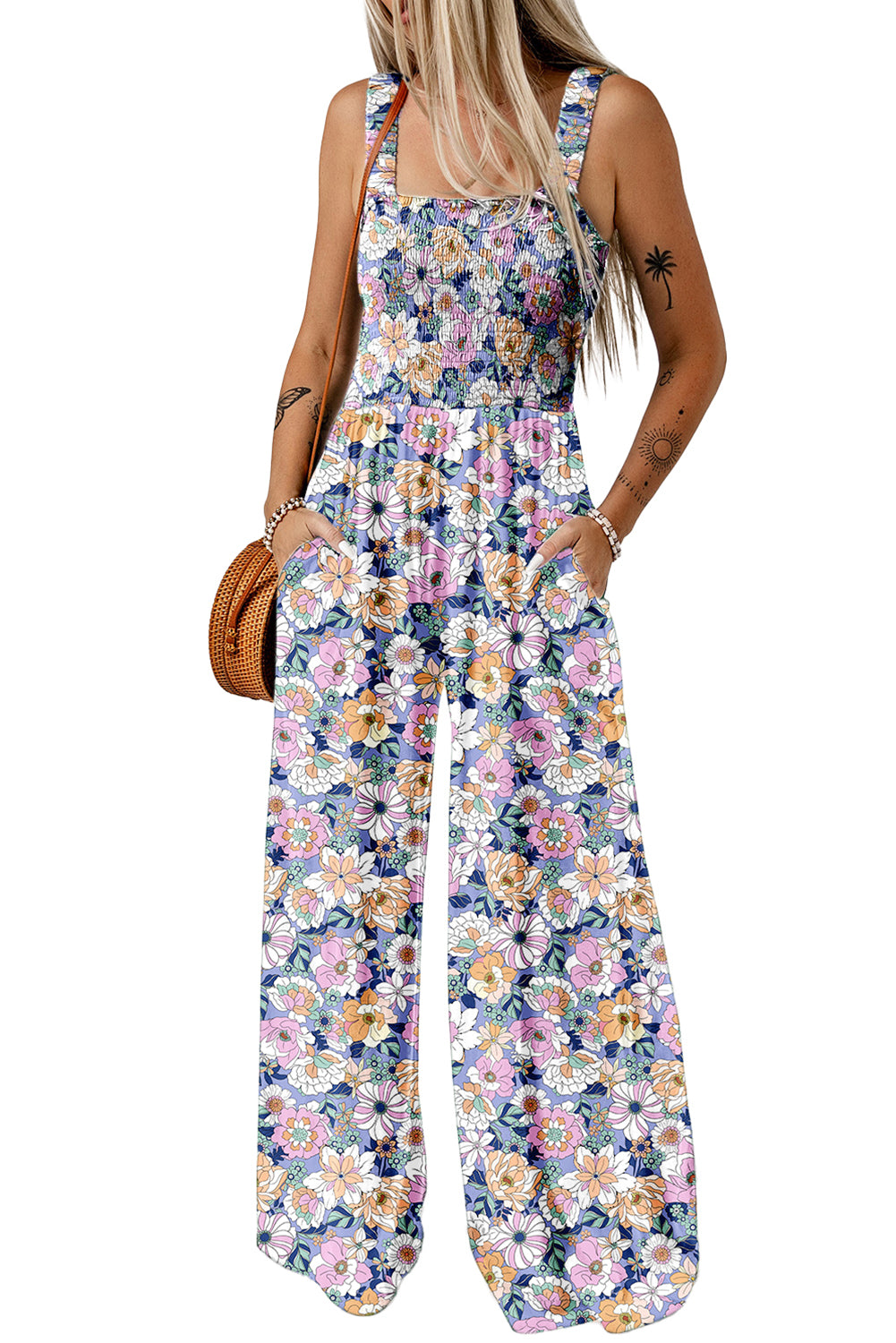 Woman wearing a floral jumpsuit on a white background