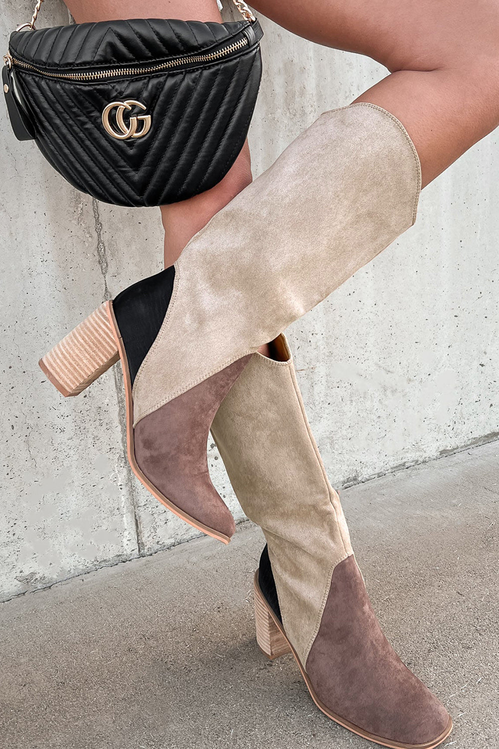 Person wearing beige and brown suede boots 