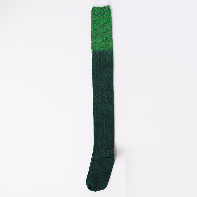 Green knee-high sock on a white background