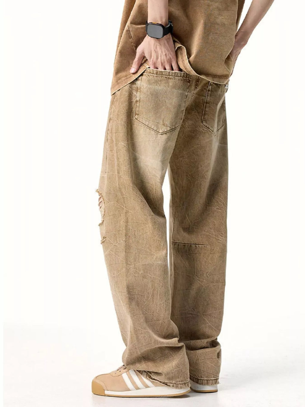 Male model wearing a pair of Men's Camel Brown Distressed Relaxed Fit Jeans angle back view