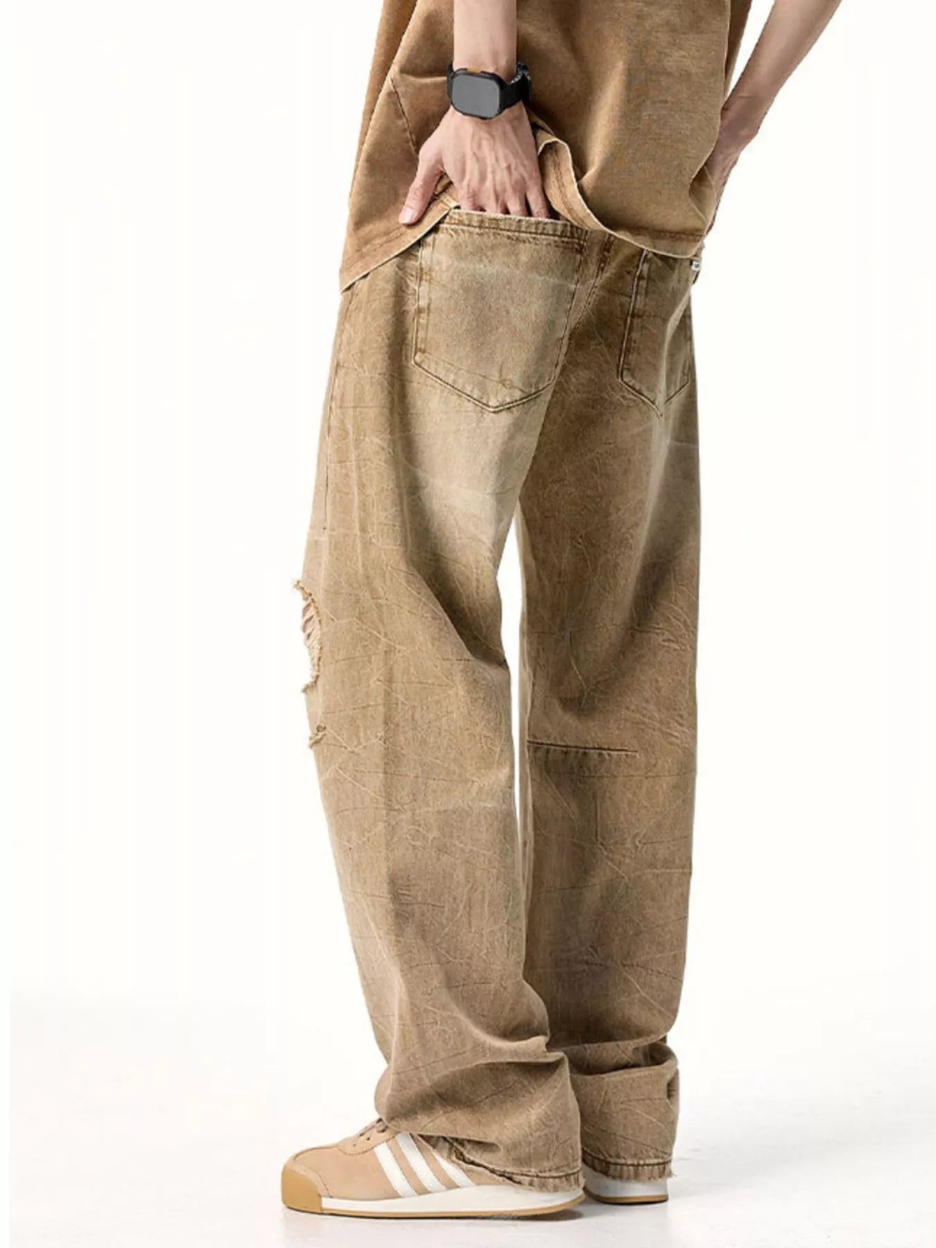 Male model wearing a pair of Men's Camel Brown Distressed Relaxed Fit Jeans angle back view