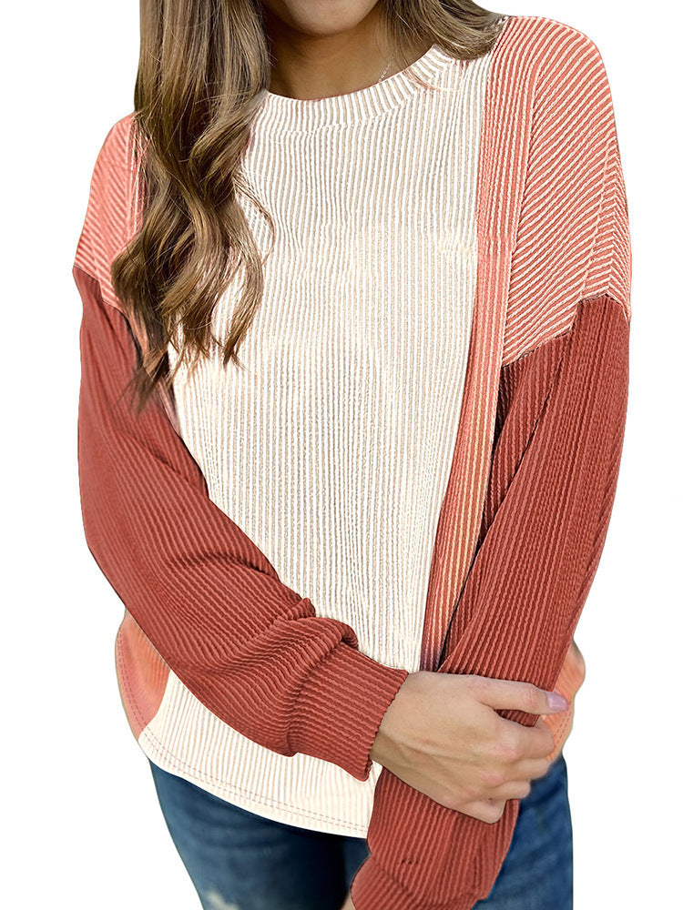 Person wearing a ribbed sweater with a white shirt underneath on a white background
