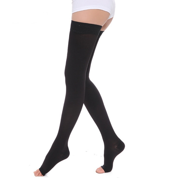 Black knee-high socks worn by a person on a white background
