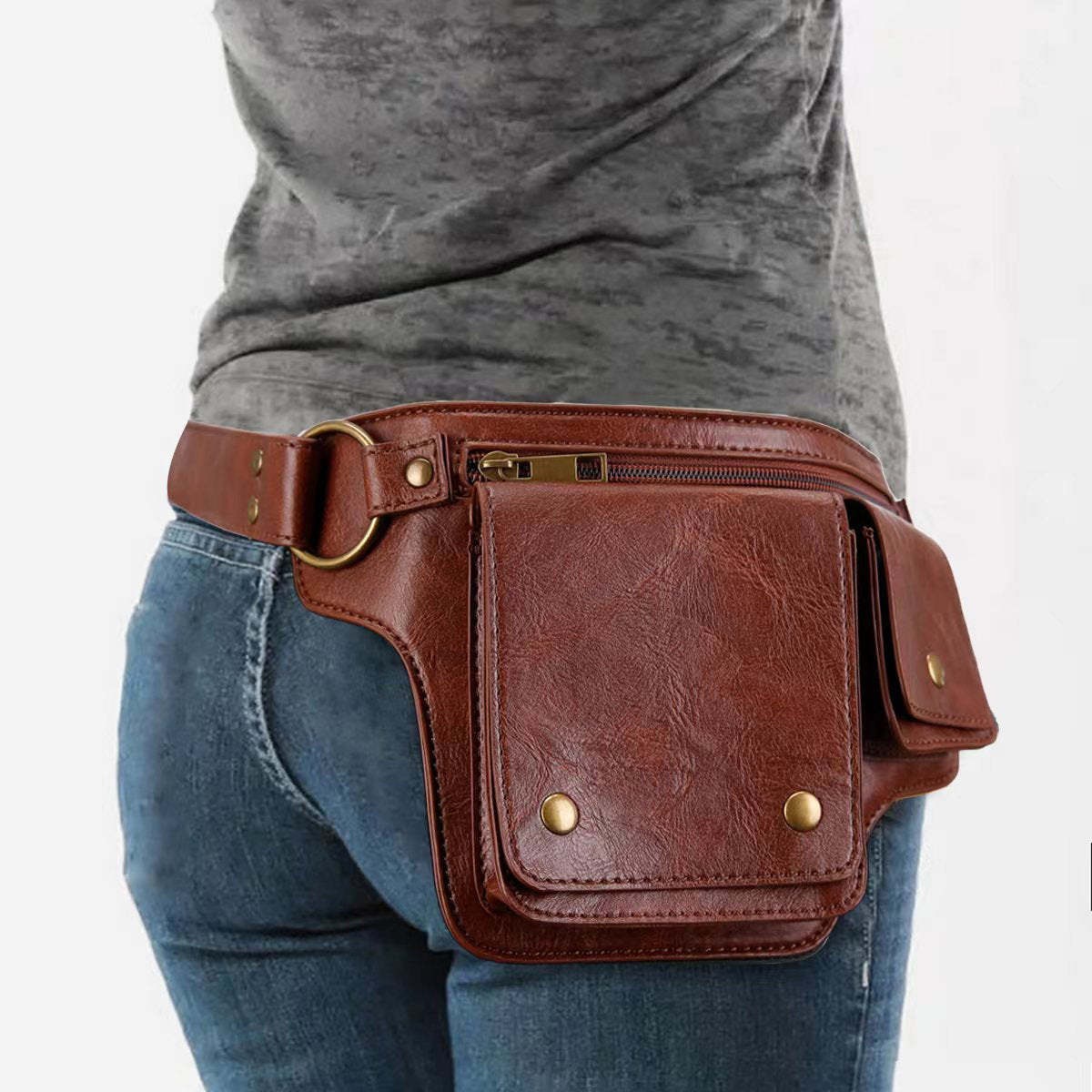 Brown leather waist bag worn by a person on a white background