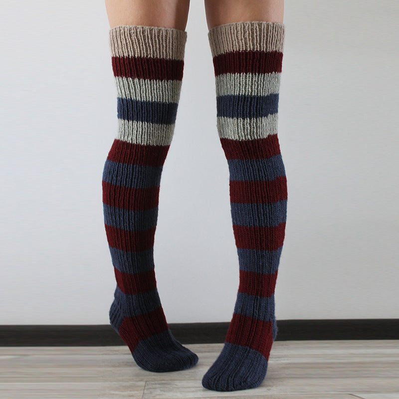 Striped knee-high socks worn by a person on a plain background