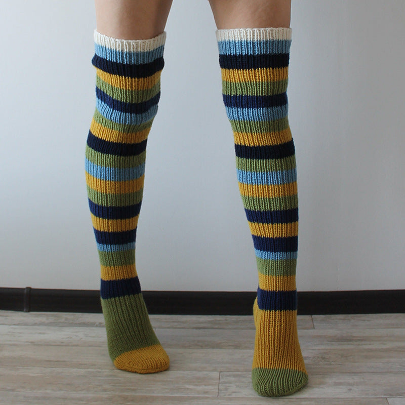 Colorful striped knee-high socks on a plain background