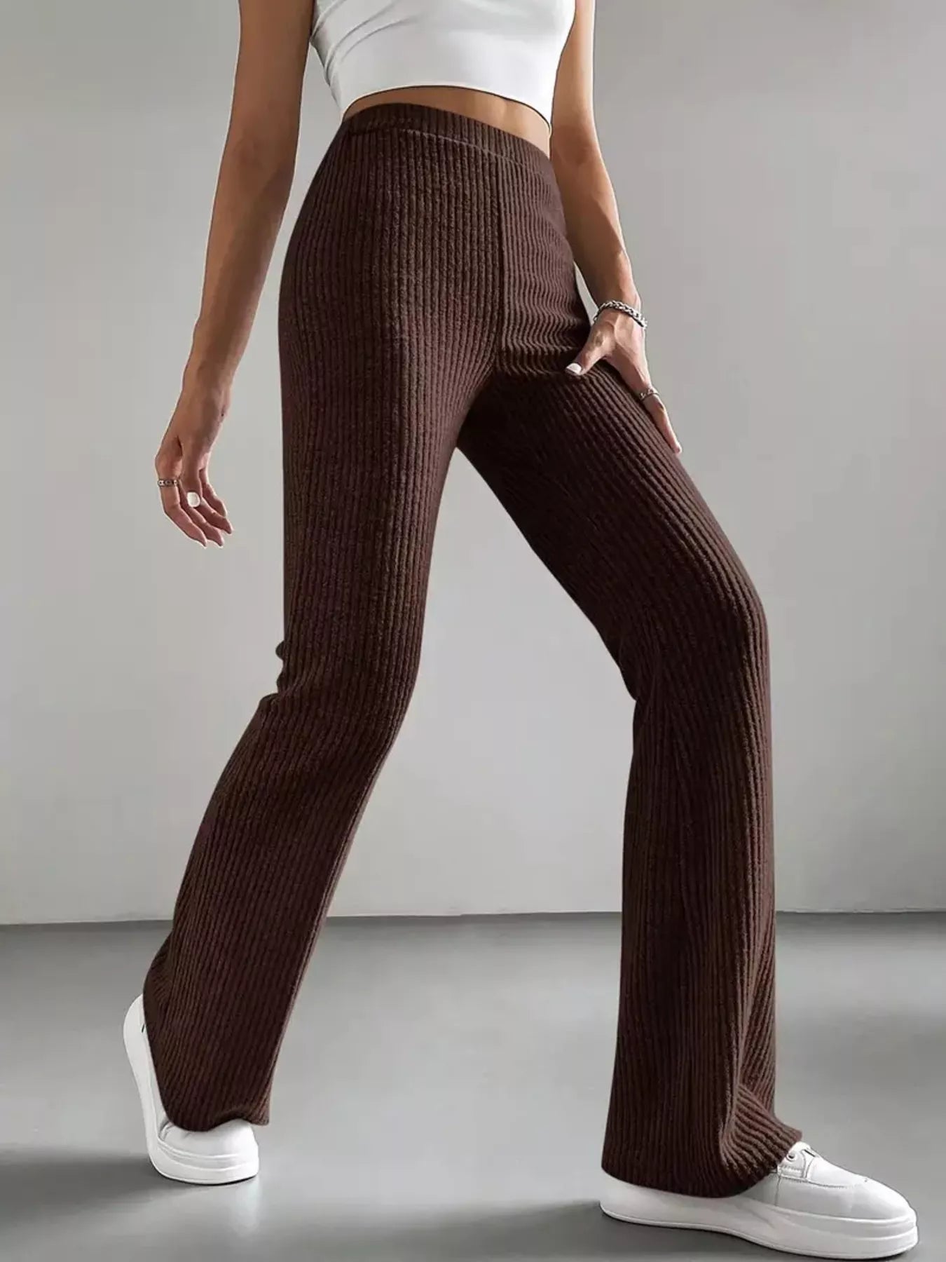 Brown ribbed pants worn by a person on a plain background