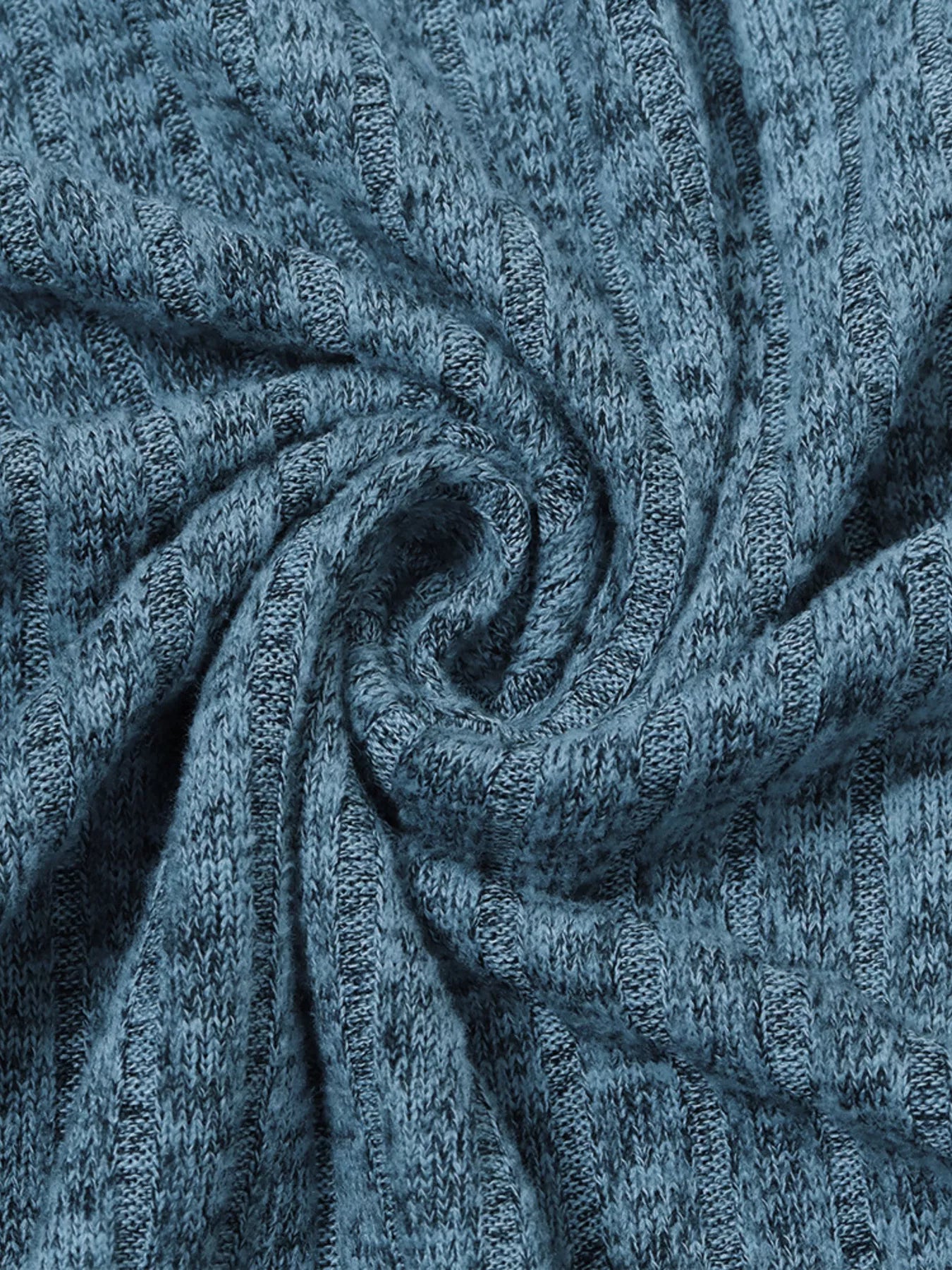 Close-up of textured blue fabric with a subtle pattern