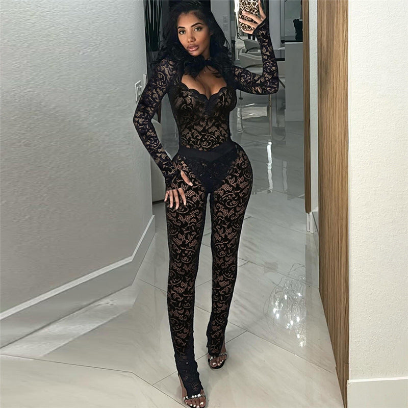 Woman wearing a black lace bodysuit in a room with light-colored floor and walls.