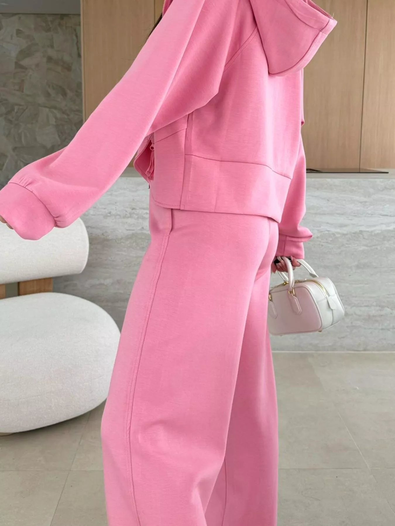 Person wearing a pink outfit with a blurred background