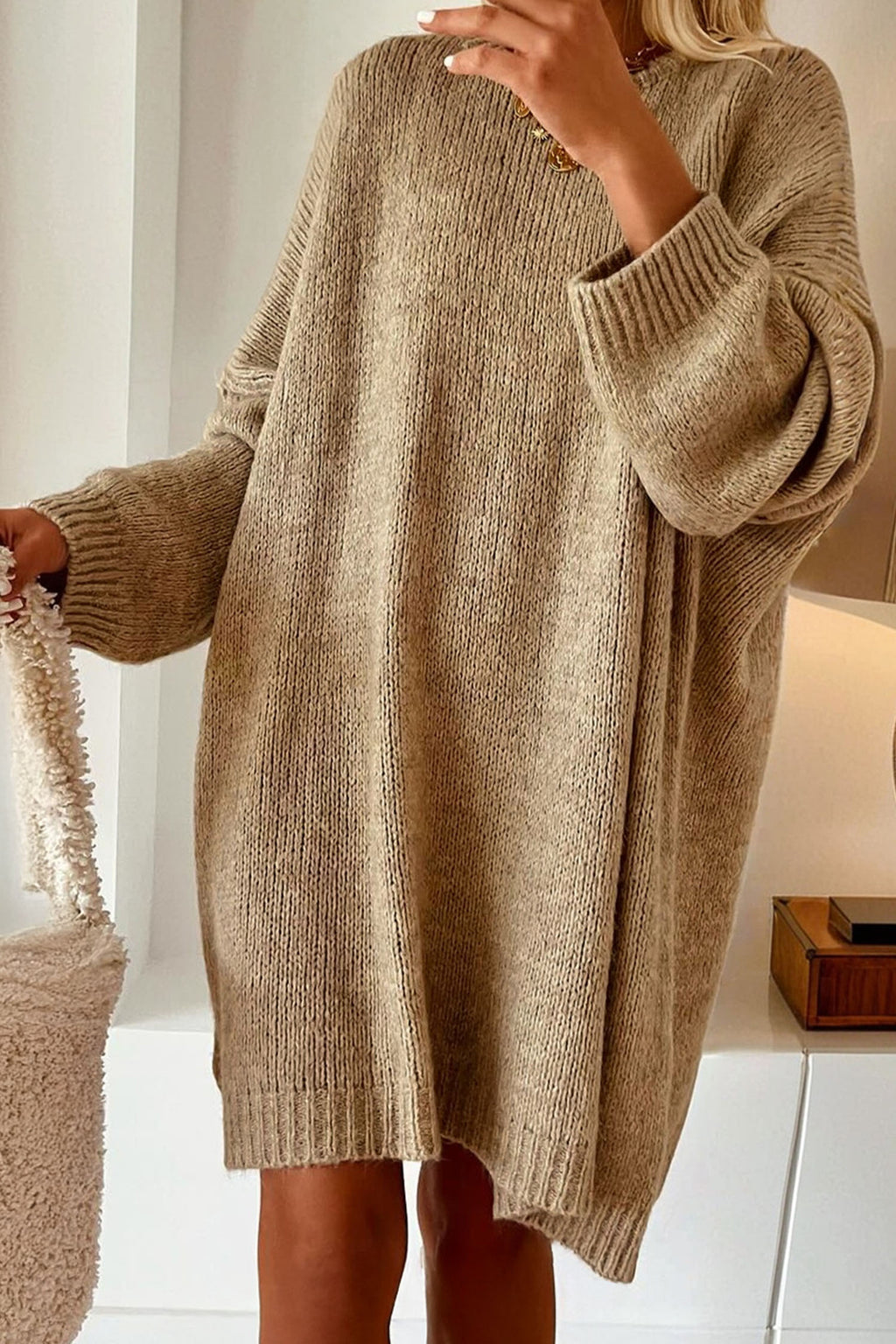 Model wearing a Women's Khaki Exposed Seam Mini Sweater Dress in a minimal indoor setting