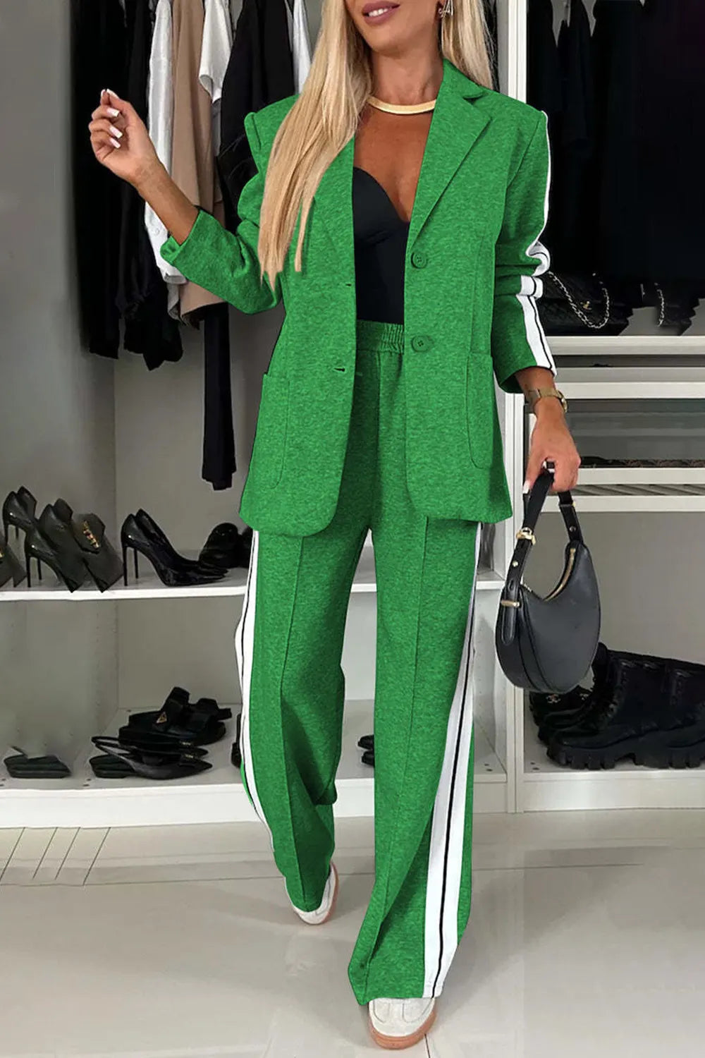 Woman wearing a green suit with white stripes in a clothing store.