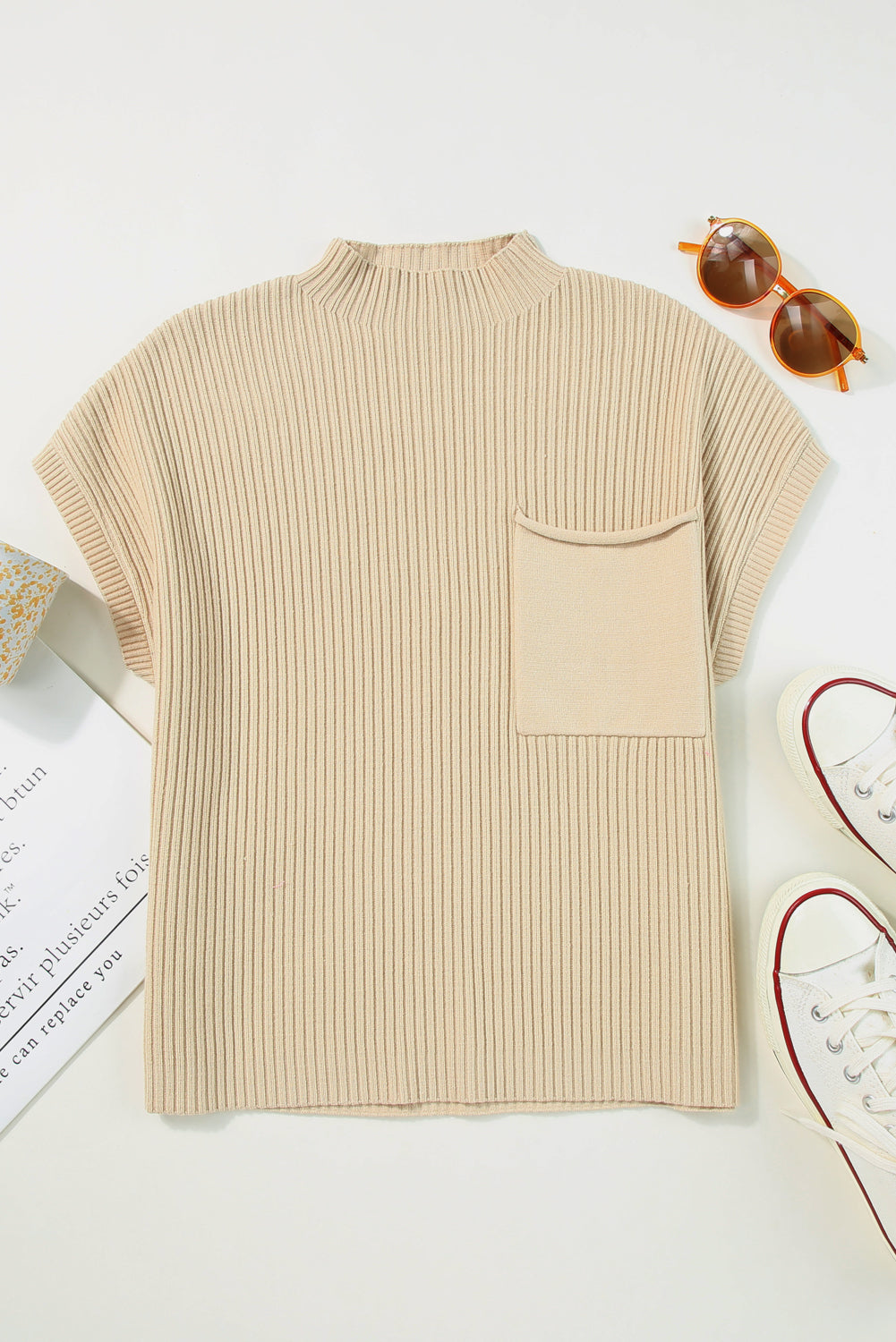Beige ribbed sweater with a pocket on a light background