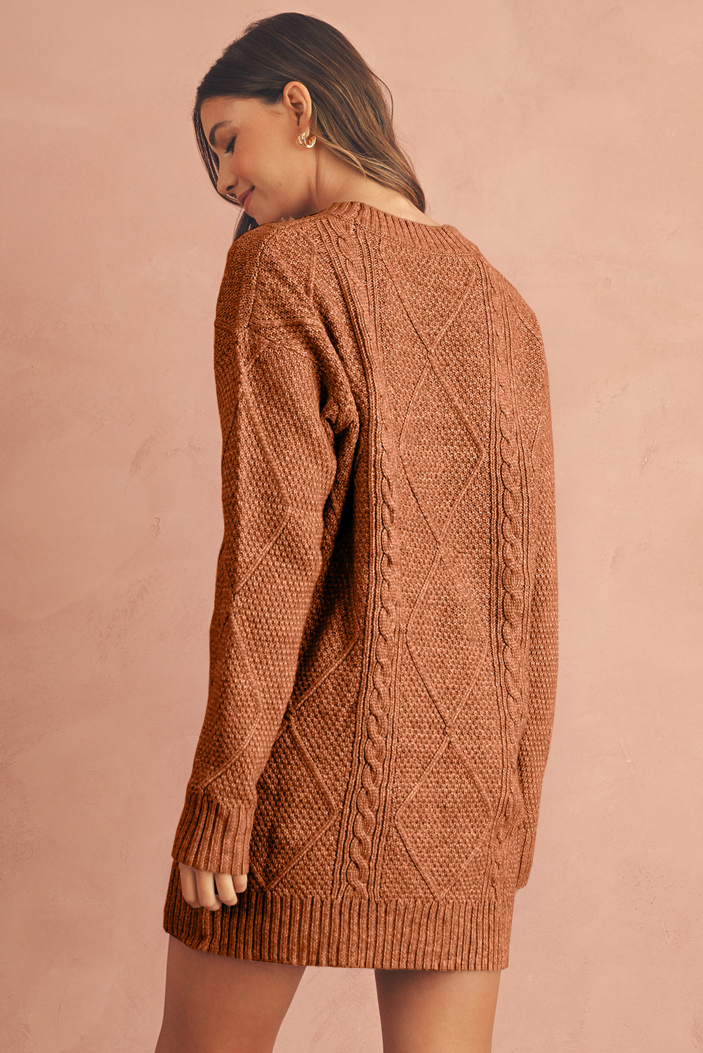 Woman wearing a coffee brown cable knit sweater back view