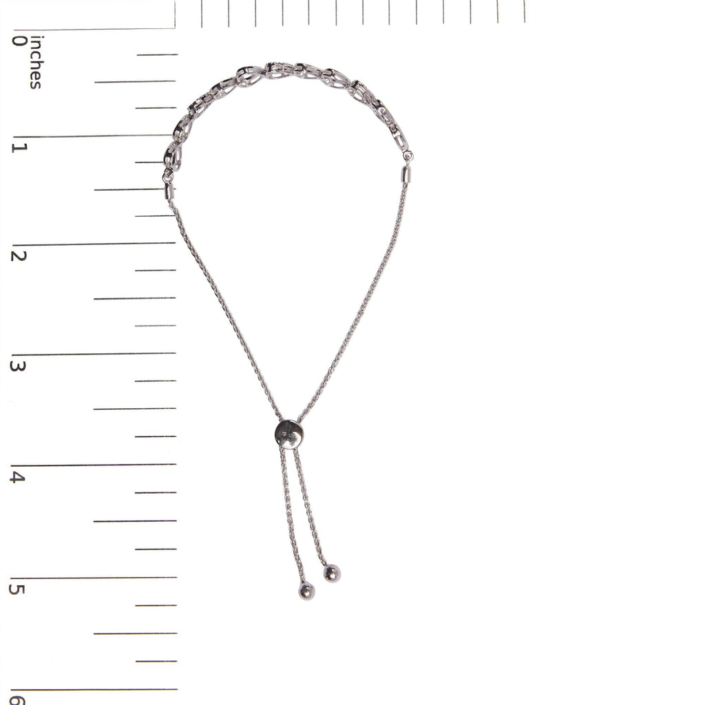 Silver chain necklace with a black bead on a white background with measurement scale.