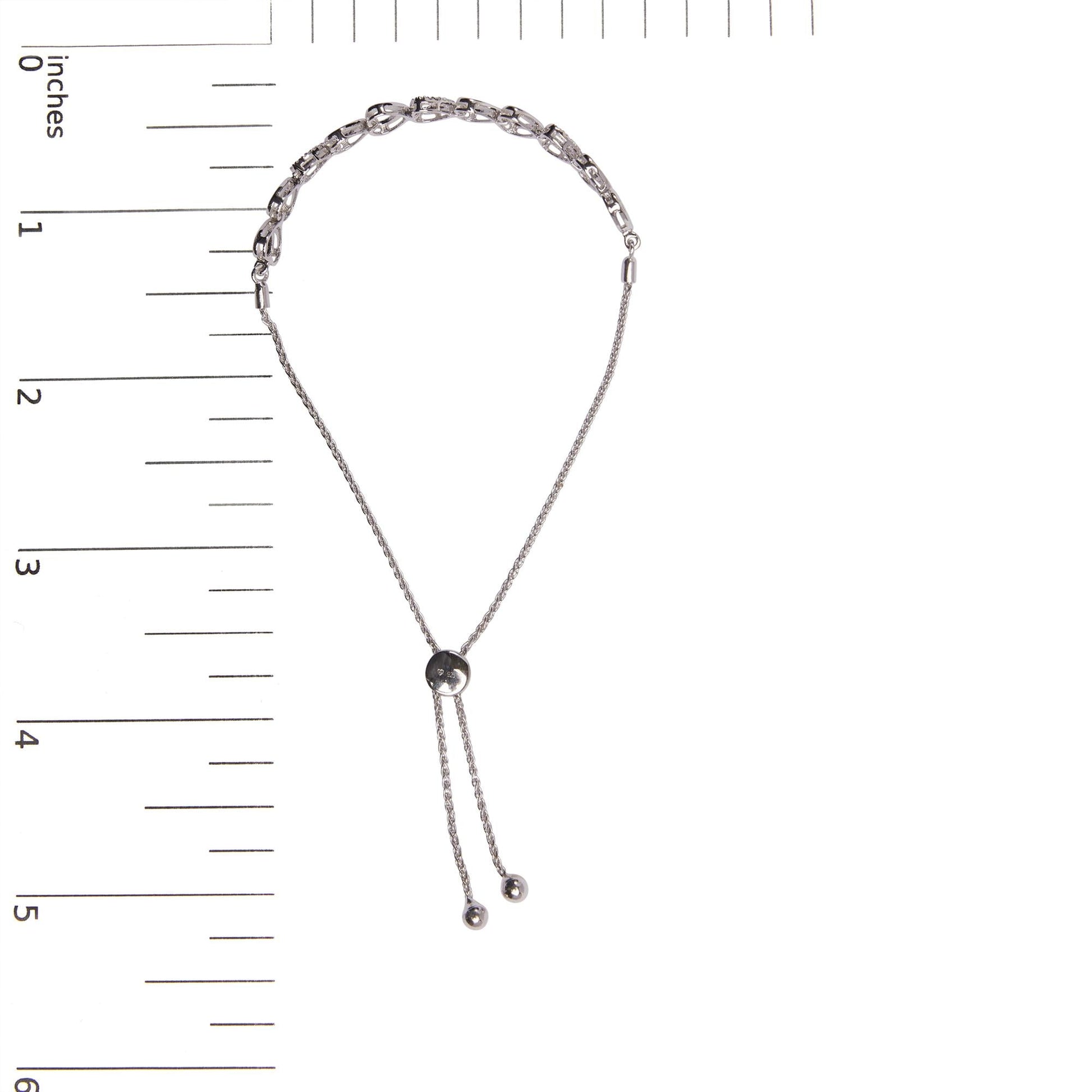 Silver chain necklace with a black bead on a white background with measurement scale.