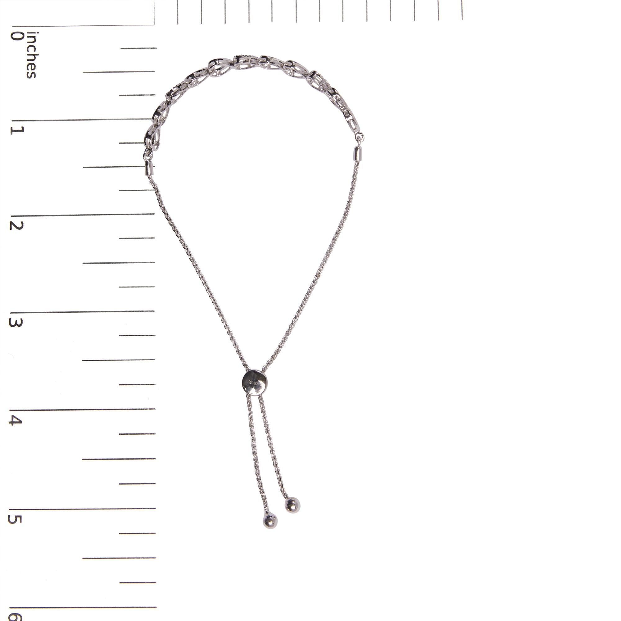 Silver chain necklace with a black bead on a white background with measurement scale.
