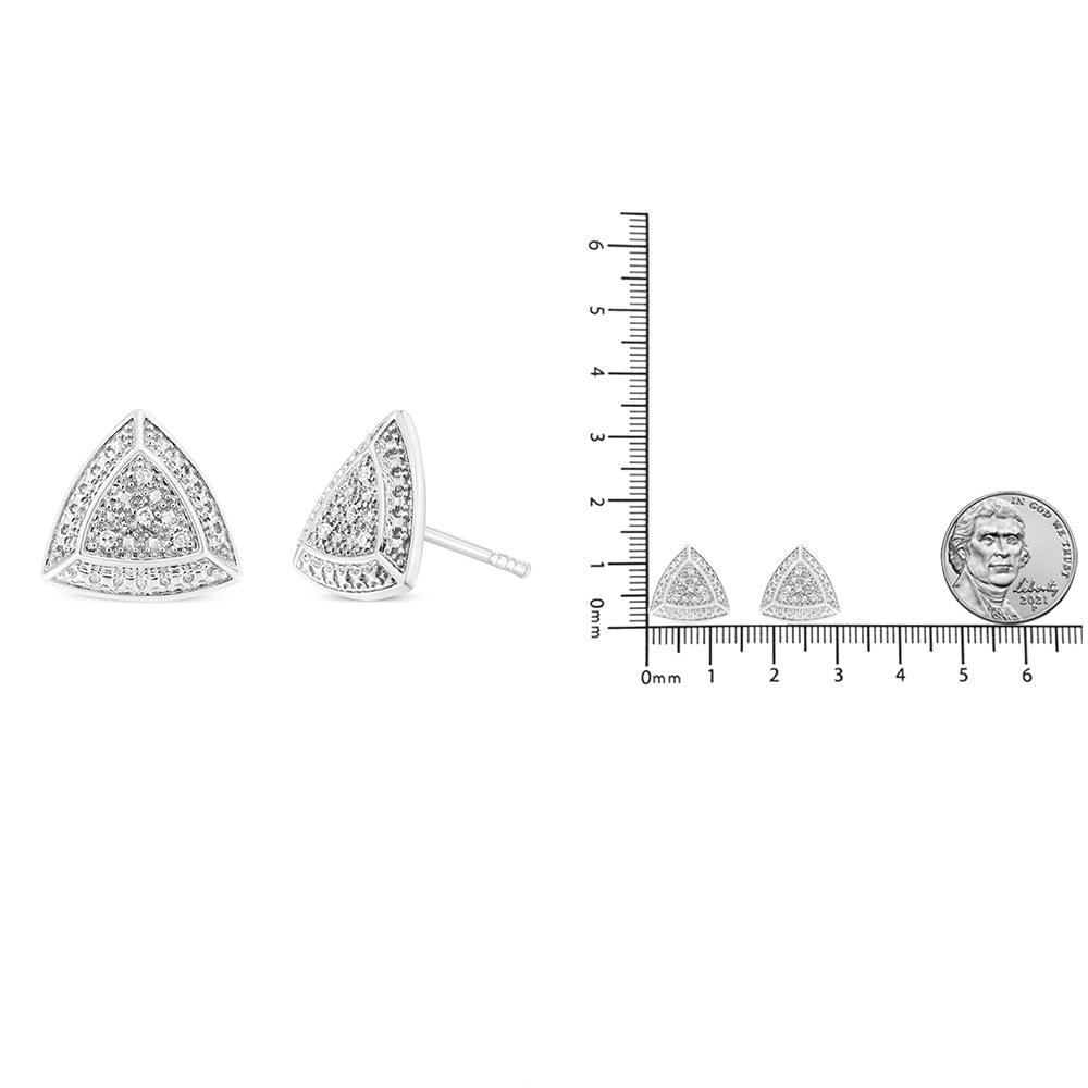 Triangular earrings with a ruler for scale on a white background