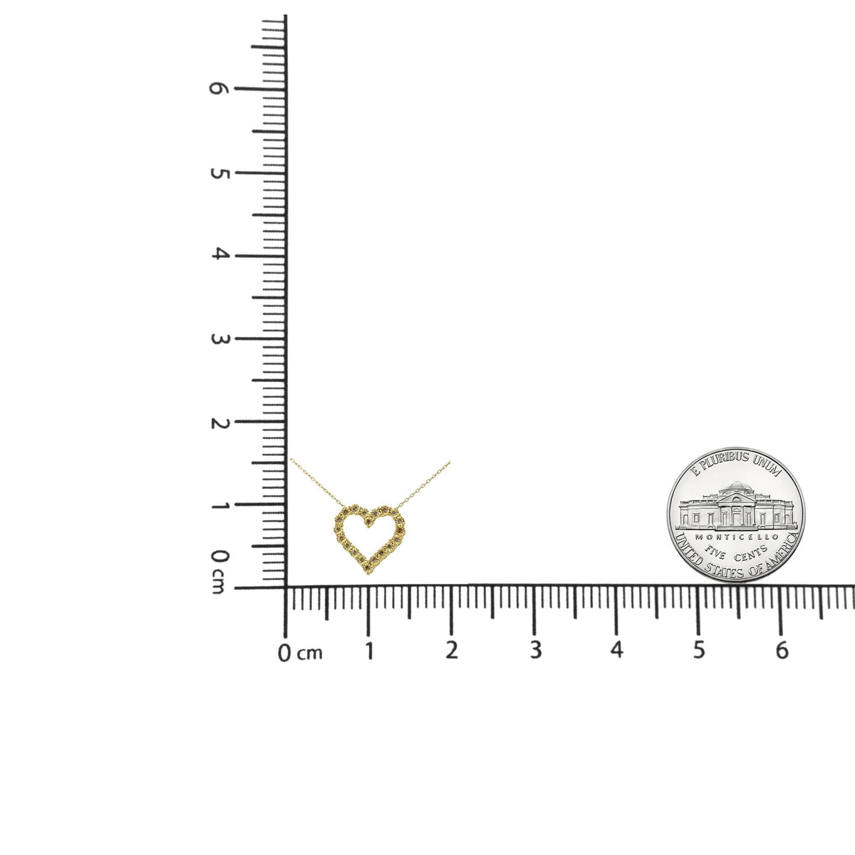 Heart-shaped pendant on a chain next to a ruler for scale, with a visible brand logo.