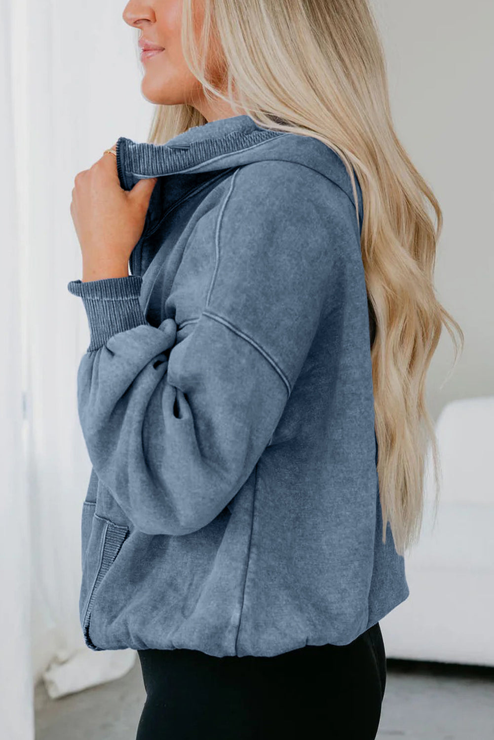 Woman wearing a blue jacket with a blurred background
