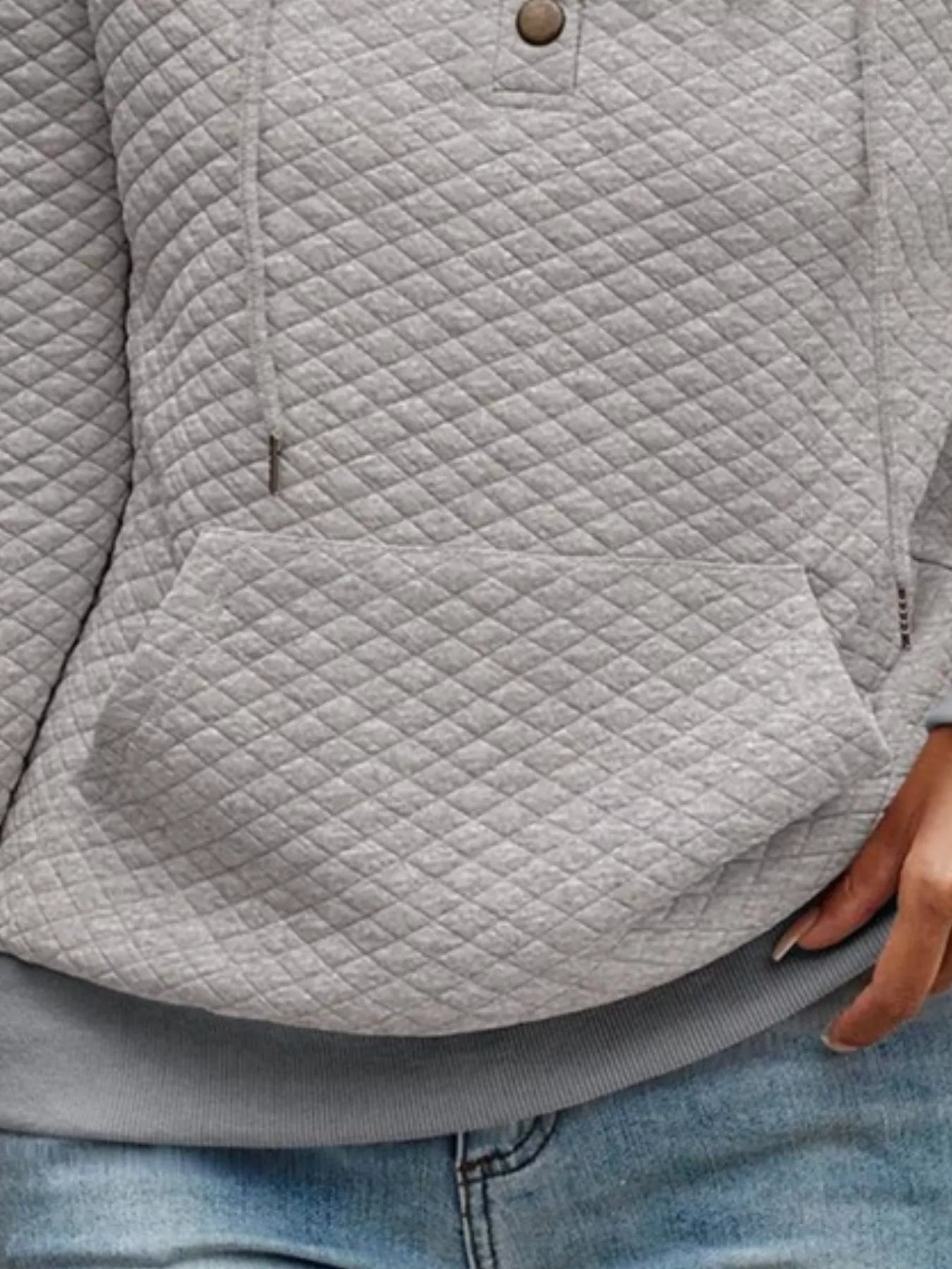 Gray quilted jacket worn by a person with jeans