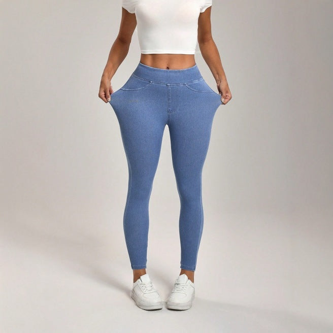 Person wearing blue leggings and white sneakers on a plain background
