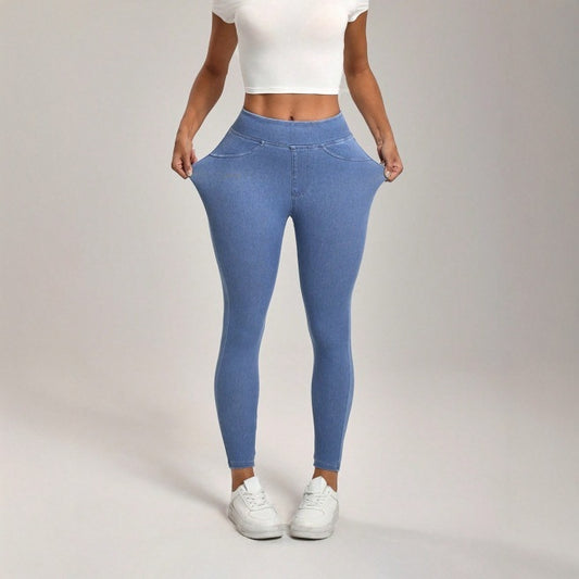 Person wearing blue leggings and white sneakers on a plain background