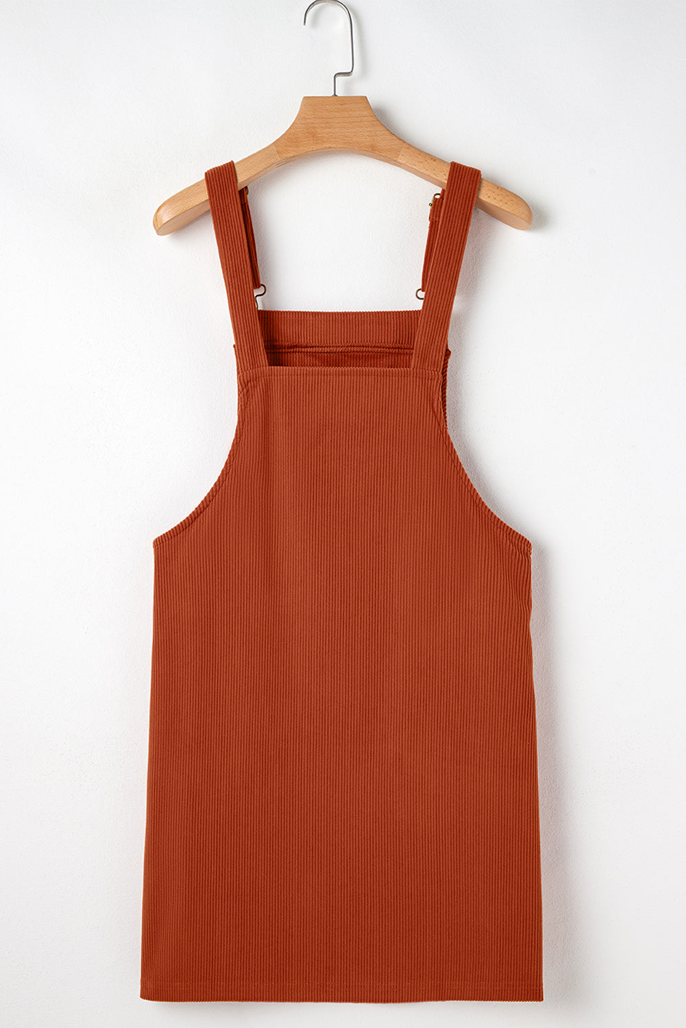 Brown ribbed tank top with straps on a wooden hanger against a white background