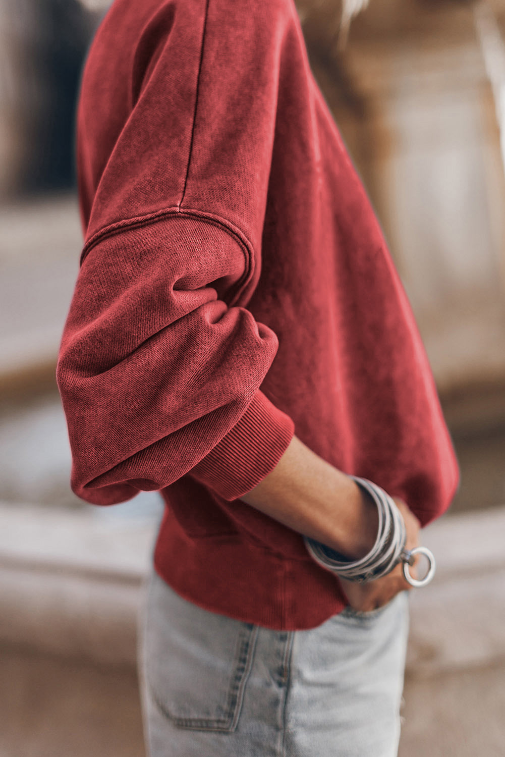 Red sweater worn by a person with blurred background